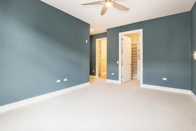 1701 W Webster Ave Unit 611, Chicago, IL 60614 - unfurnished bedroom with light carpet, baseboards, a walk in closet, a closet, and a ceiling fan