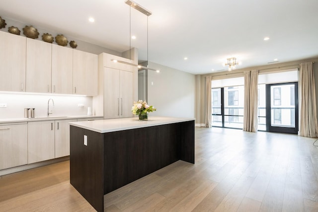 1701 W Webster Ave Unit 611, Chicago, IL 60614 - kitchen with a center island, light countertops, open floor plan, modern cabinets, and light wood-style floors