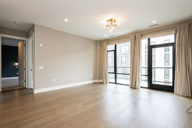 1701 W Webster Ave Unit 611, Chicago, IL 60614 - spare room featuring wood finished floors, a chandelier, baseboards, recessed lighting, and a smoke detector