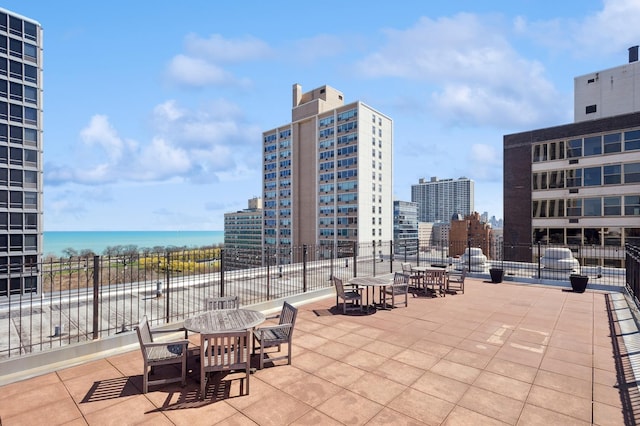 view of patio / terrace with a water view and a city view