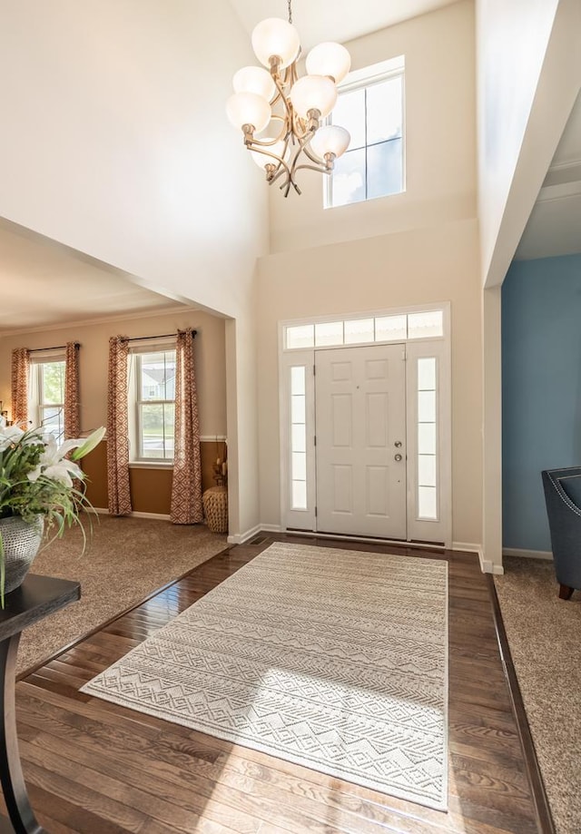 3080 Wickenden Ave, Elgin, IL 60124 - foyer featuring a chandelier, baseboards, wood finished floors, and a towering ceiling