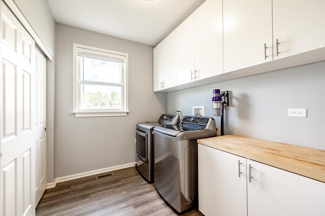 3080 Wickenden Ave, Elgin, IL 60124 - laundry room featuring cabinet space, washing machine and dryer, wood finished floors, and baseboards