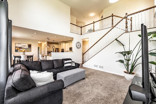 3080 Wickenden Ave, Elgin, IL 60124 - carpeted living room featuring stairway, baseboards, a high ceiling, and recessed lighting