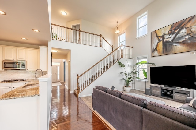 3080 Wickenden Ave, Elgin, IL 60124 - living area featuring stairs, baseboards, a high ceiling, recessed lighting, and wood finished floors