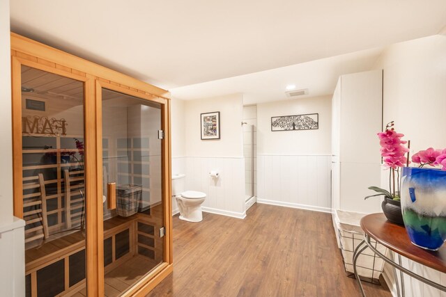 3080 Wickenden Ave, Elgin, IL 60124 - full bath featuring wood finished floors, toilet, a stall shower, and wainscoting