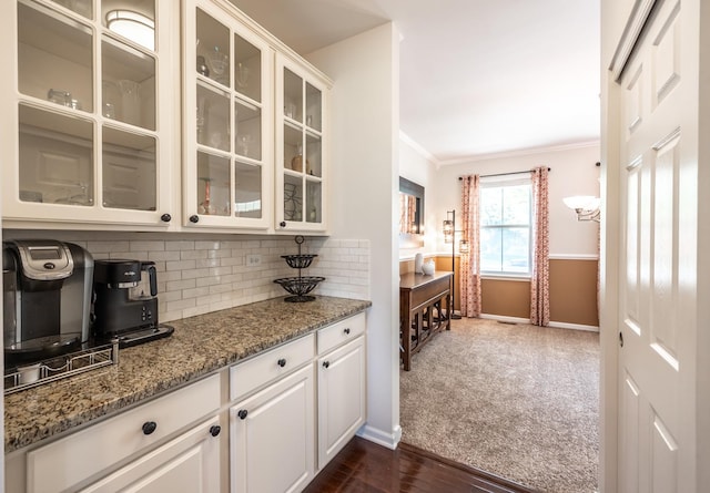 3080 Wickenden Ave, Elgin, IL 60124 - kitchen featuring crown molding, glass insert cabinets, backsplash, stone countertops, and baseboards
