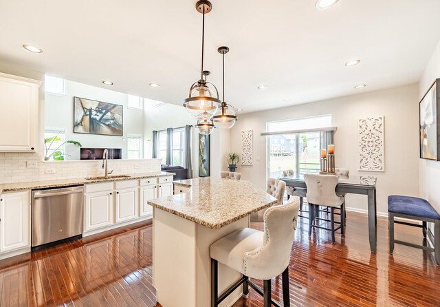 3080 Wickenden Ave, Elgin, IL 60124 - kitchen with stainless steel dishwasher, a sink, dark wood-style floors, white cabinets, and recessed lighting