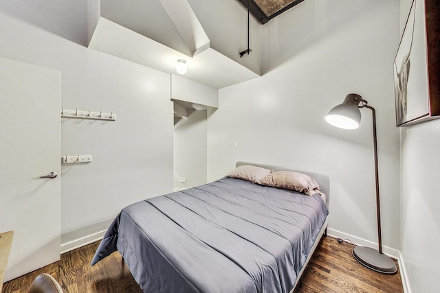 bedroom featuring wood finished floors and baseboards