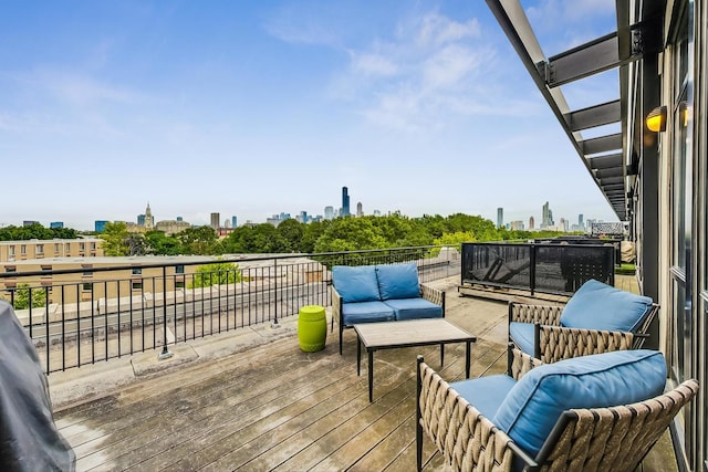 wooden deck featuring a view of skyline and outdoor lounge area