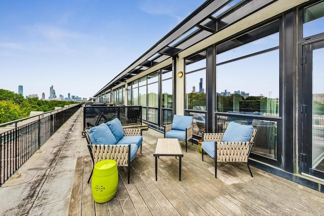 view of patio featuring an outdoor living space, a skyline view, and a wooden deck