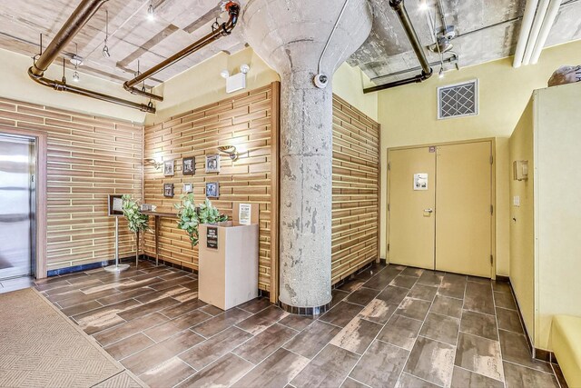 reception with brick wall and a towering ceiling