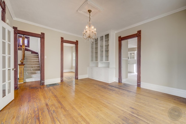 125 Arbor Ave, West Chicago, IL 60185 - empty room featuring a chandelier, stairway, wood finished floors, baseboards, and ornamental molding