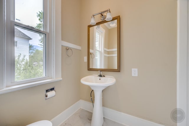 125 Arbor Ave, West Chicago, IL 60185 - half bathroom with plenty of natural light, baseboards, marble look tile flooring, and a sink