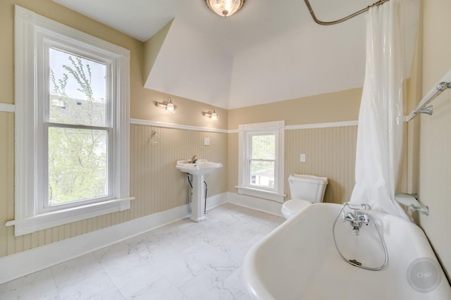 125 Arbor Ave, West Chicago, IL 60185 - bathroom with marble finish floors, wainscoting, toilet, a bath, and baseboards