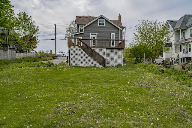 125 Arbor Ave, West Chicago, IL 60185 - rear view of property with a chimney, a wooden deck, stairway, and a lawn