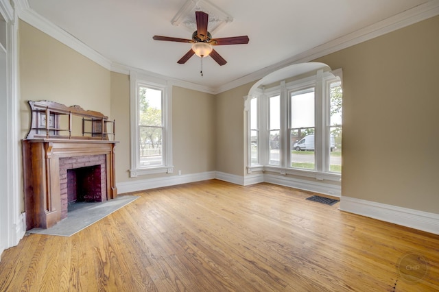 125 Arbor Ave, West Chicago, IL 60185 - unfurnished living room featuring wood finished floors, ceiling fan, a brick fireplace, baseboards, and crown molding