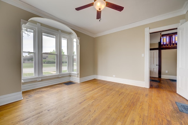 125 Arbor Ave, West Chicago, IL 60185 - empty room with a ceiling fan, crown molding, light wood-type flooring, baseboards, and arched walkways