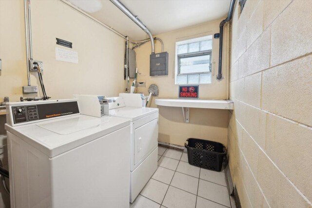 6357 W Addison St Unit Gse, Chicago, IL 60634 - shared laundry featuring electric panel, washing machine and dryer, and light tile patterned flooring
