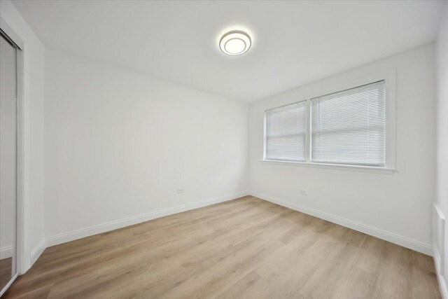 6357 W Addison St Unit Gse, Chicago, IL 60634 - empty room with light wood-style floors and baseboards