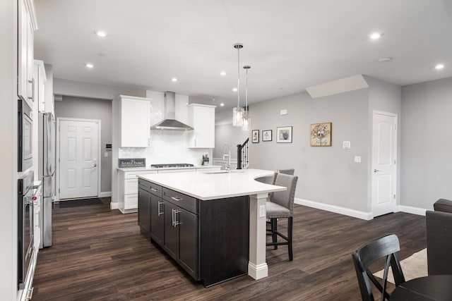2234 Weatherbee Ln, Naperville, IL 60563 - kitchen featuring wall chimney range hood, stainless steel appliances, a breakfast bar area, dark wood finished floors, and decorative backsplash