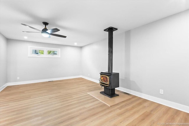 266 Merrill Ave, Calumet City, IL 60409 - unfurnished living room featuring a wood stove, wood finished floors, ceiling fan, baseboards, and recessed lighting