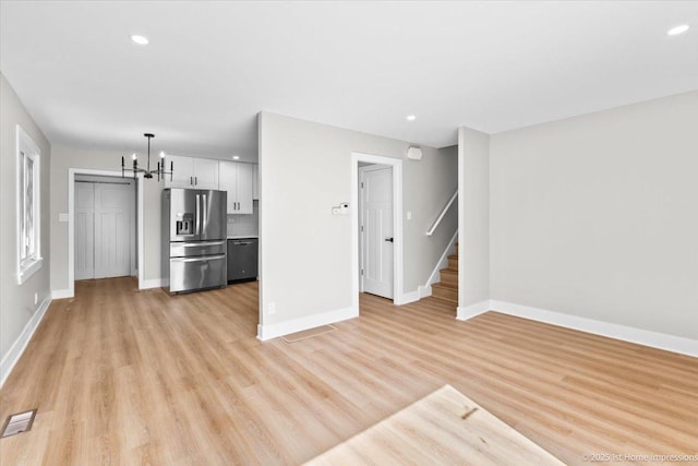 266 Merrill Ave, Calumet City, IL 60409 - unfurnished living room featuring a chandelier, baseboards, stairs, and recessed lighting