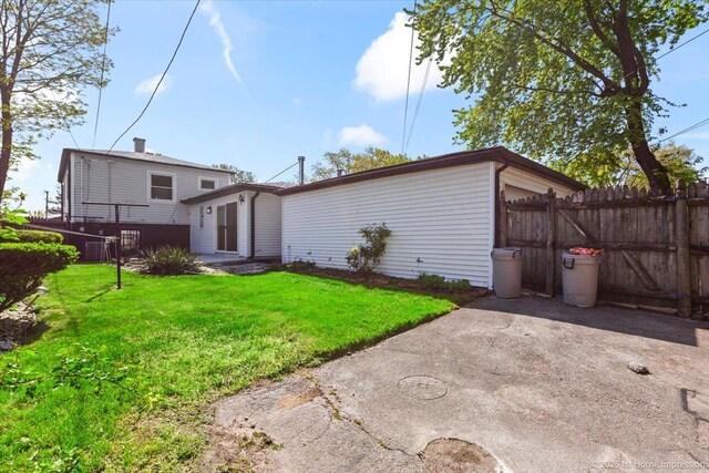 266 Merrill Ave, Calumet City, IL 60409 - back of house featuring driveway, a garage, and a patio