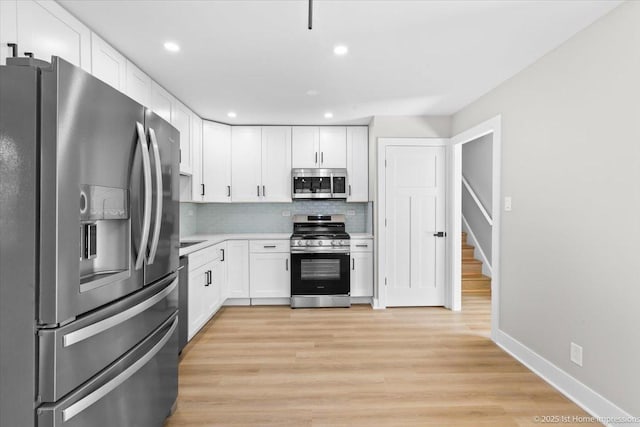 266 Merrill Ave, Calumet City, IL 60409 - kitchen with stainless steel appliances, light countertops, white cabinets, decorative backsplash, and baseboards