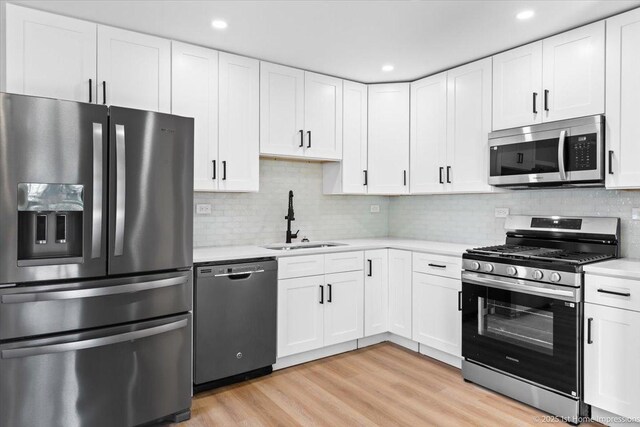 266 Merrill Ave, Calumet City, IL 60409 - kitchen with stainless steel appliances, a sink, light countertops, white cabinets, and recessed lighting