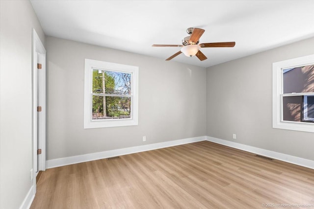 266 Merrill Ave, Calumet City, IL 60409 - unfurnished room featuring light wood-style flooring, ceiling fan, and baseboards