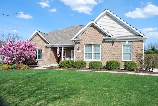 1123 Redbud Ln, Sugar Grove, IL 60554 - view of front of home featuring a front yard, brick siding, and covered porch
