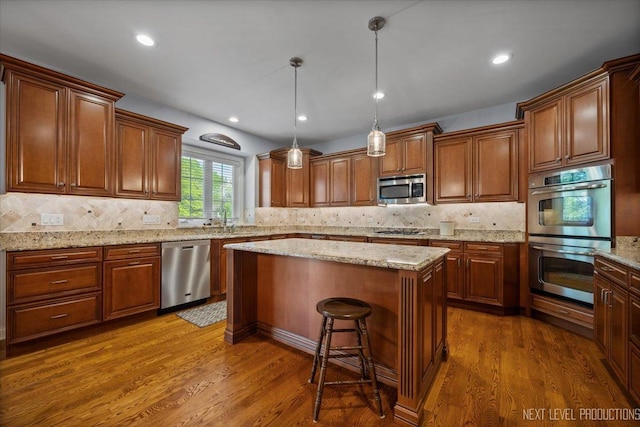 1123 Redbud Ln, Sugar Grove, IL 60554 - kitchen with appliances with stainless steel finishes, dark wood-style floors, a center island, decorative backsplash, and recessed lighting