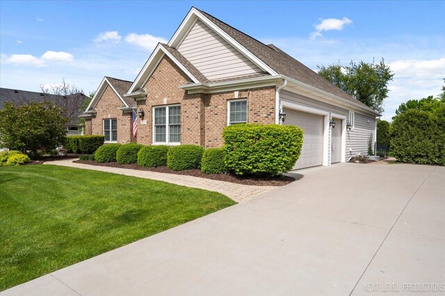 1123 Redbud Ln, Sugar Grove, IL 60554 - view of front of home featuring brick siding, concrete driveway, a front lawn, and a garage