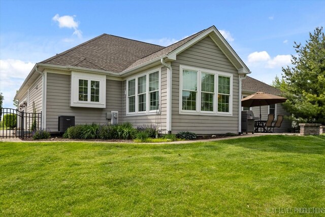 1123 Redbud Ln, Sugar Grove, IL 60554 - view of side of property featuring a lawn, roof with shingles, and a patio area