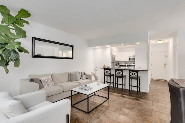 living area with stone finish flooring and recessed lighting