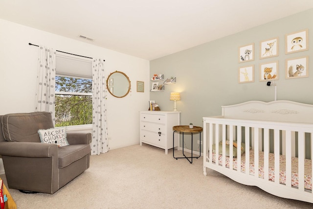 bedroom with carpet floors and a nursery area