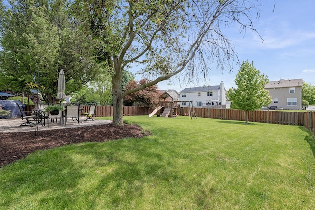 view of yard with a playground and a patio