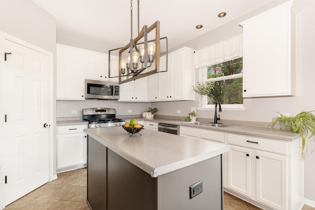 kitchen featuring stainless steel appliances, a sink, white cabinetry, pendant lighting, and recessed lighting
