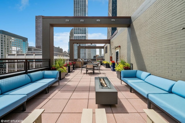 247 E Chestnut St Unit 1603, Chicago, IL 60611 - view of patio / terrace featuring an outdoor living space with a fire pit, outdoor dining space, and a view of city