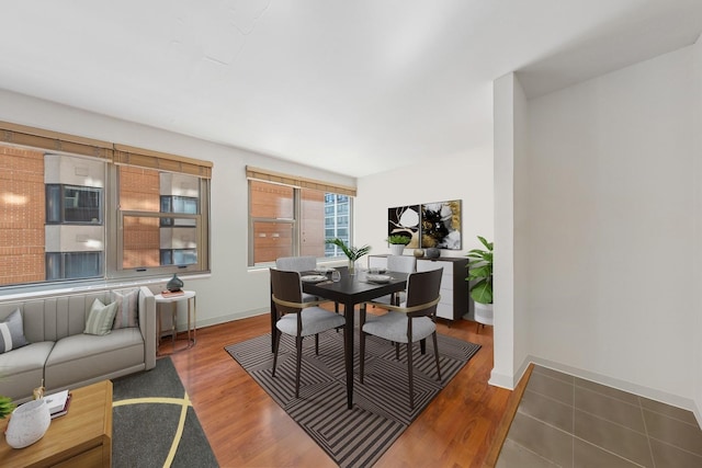 247 E Chestnut St Unit 1603, Chicago, IL 60611 - dining space featuring baseboards and wood finished floors