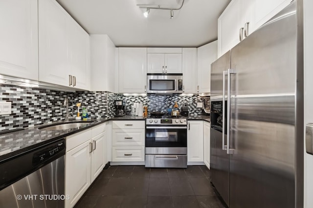247 E Chestnut St Unit 1603, Chicago, IL 60611 - kitchen with appliances with stainless steel finishes, a sink, dark tile patterned flooring, white cabinetry, and tasteful backsplash