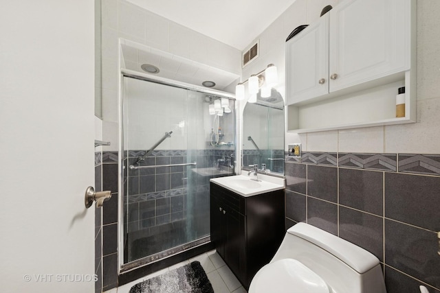 247 E Chestnut St Unit 1603, Chicago, IL 60611 - bathroom featuring a stall shower, tile walls, vanity, toilet, and tile patterned floors