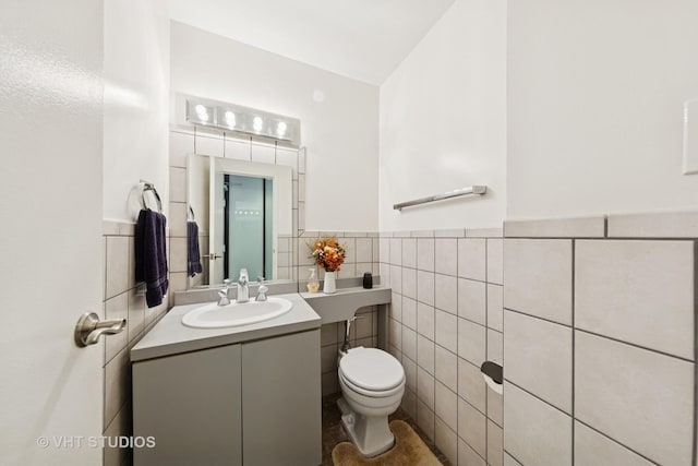 247 E Chestnut St Unit 1603, Chicago, IL 60611 - bathroom with toilet, tile walls, a wainscoted wall, and vanity