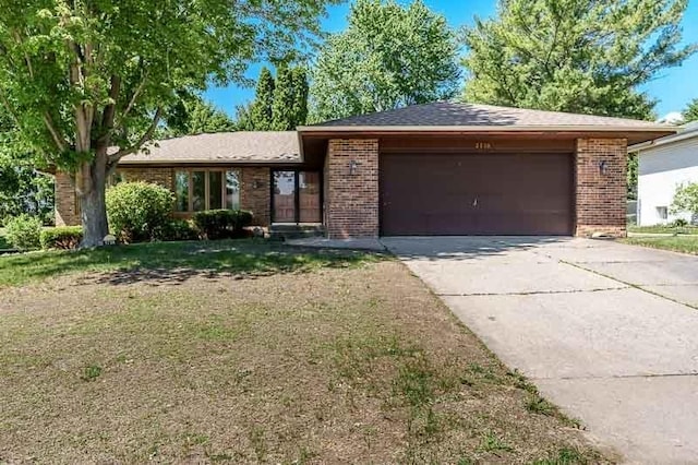 5718 Tasselbury Close, Rockford, IL 61114 - single story home with brick siding, a garage, concrete driveway, and a front lawn