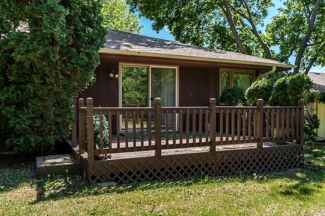 5718 Tasselbury Close, Rockford, IL 61114 - back of property with roof with shingles, a wooden deck, and a yard