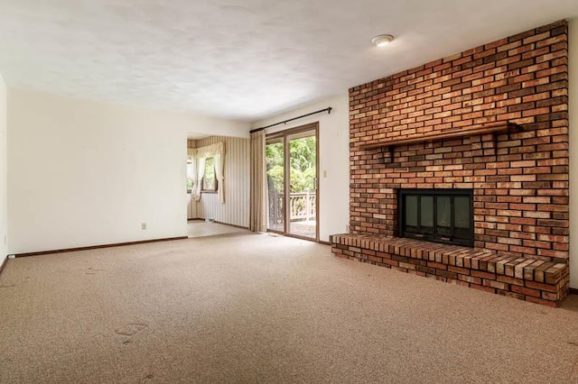 5718 Tasselbury Close, Rockford, IL 61114 - unfurnished living room with carpet floors, a brick fireplace, baseboards, and a textured ceiling