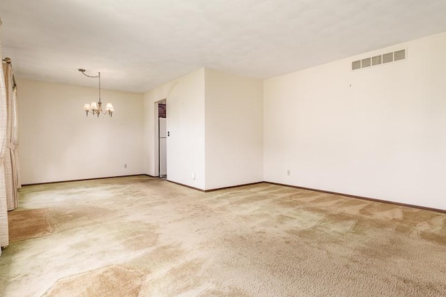5718 Tasselbury Close, Rockford, IL 61114 - spare room featuring a chandelier, light colored carpet, and baseboards