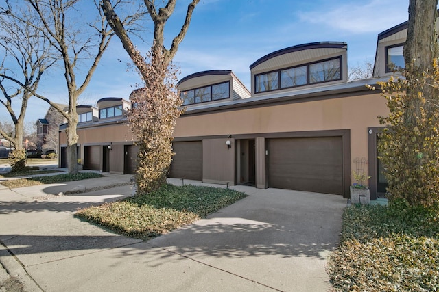241 E Burlington St Unit C, Riverside, IL 60546 - view of front of home featuring driveway, a garage, and stucco siding