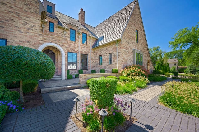 31 Concord Dr, Oak Brook, IL 60523 - view of front of property with brick siding, a chimney, and a high end roof