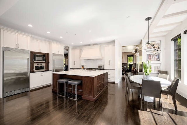 31 Concord Dr, Oak Brook, IL 60523 - kitchen featuring built in appliances, custom range hood, dark wood finished floors, plenty of natural light, and recessed lighting